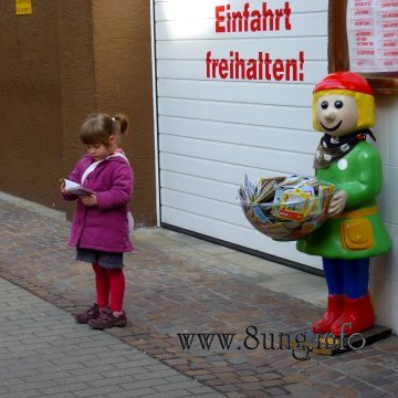 Faszination Buch: mädchen liest konzentriert auf der strasse