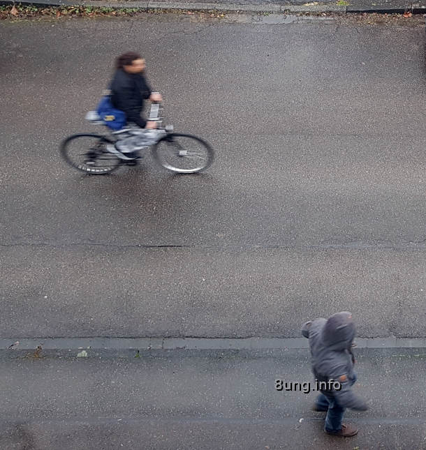 Wetter im august 2021 laut Rauhnächten - Radler und Fußgänger auf regennasser Straße