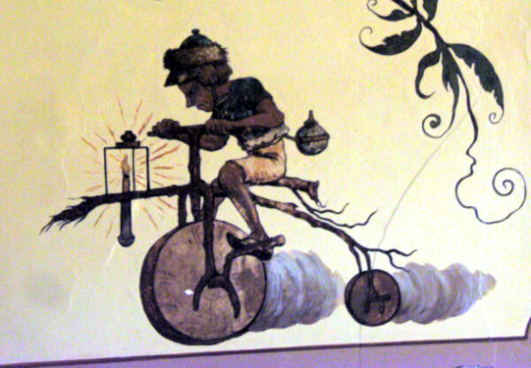 Prokrastination - Bild eines Steinzeitmenschen, der auf einem Fahrrad fährt, dessen Räder aus Steinen sind
