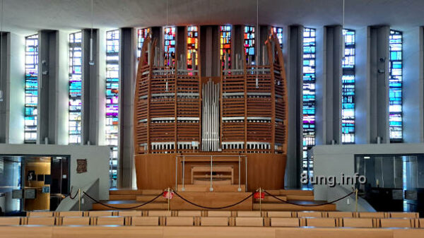 Orgel vor roten und blauen Glasfenstern